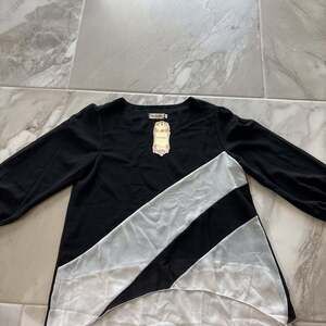 XinXinJia Black and White Asymmetrical Blouse, Size M, Long Sleeve Casual Top